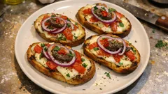Crostini alla napoletana: knusprig überbacken mit Tomate, Mozzarella und Zwiebel